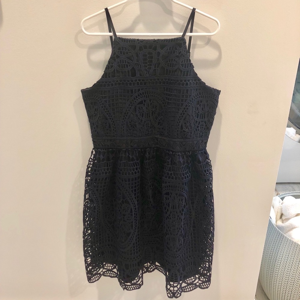 A navy dress with floral lace detailing